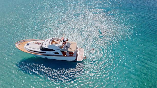 Aerial view of family swimming and sunbathing in Adriatic Sea during vacation.