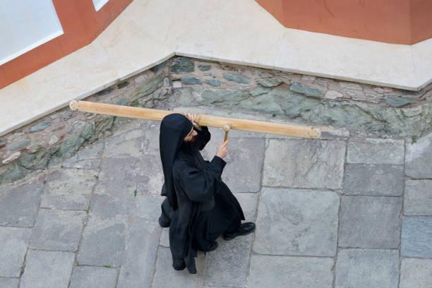 Greece, Chalkidiki, Mount Athos peninsula, World Heritage Site, Dionysiou monastery, Monk calling the faithful to the vespers with a simandra